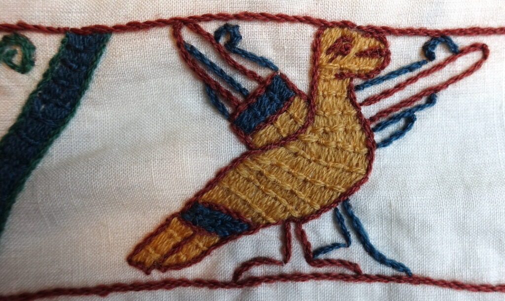 An embroidered golden bird, a motif from the top of the tapestry