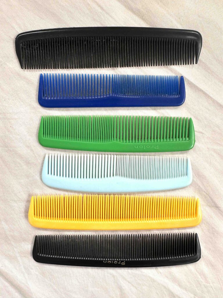 Six coloured plastic combs laid out